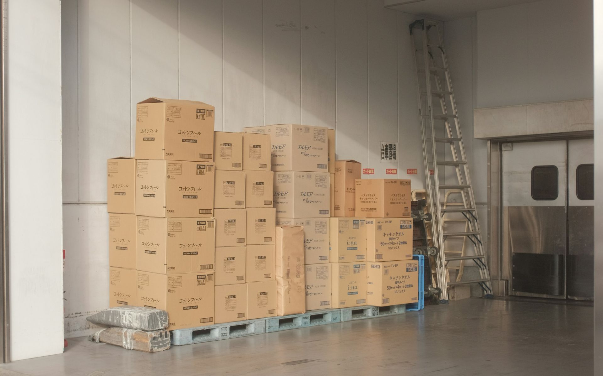 brown cardboard boxes on white floor tiles